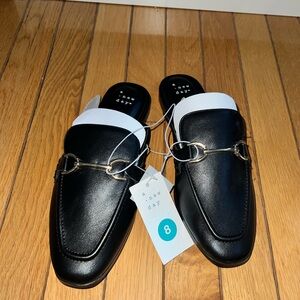 A new day black mules with silver detail.